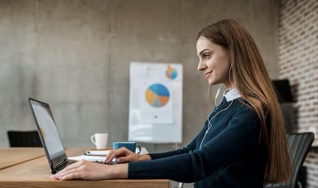 Girl working on a laptop in the office