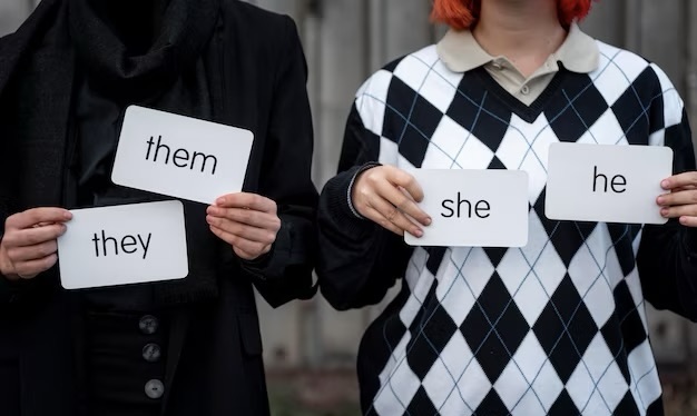 People holding cards with pronouns, front view